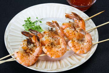 Grilled prawn skewer with sauce