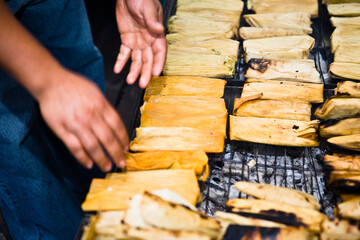 Mid section view of a man roasting tamales on barbecue grill, Zacatecas State, Mexico