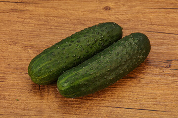 Green fresh cucumbers over background