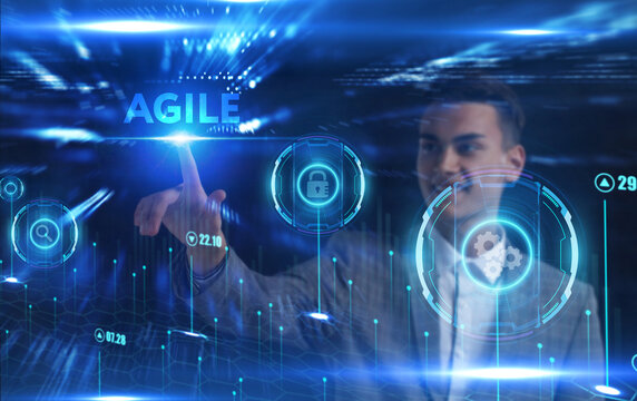 Business, Technology, Internet and network concept. Young businessman working on a virtual screen of the future and sees the inscription: Agile