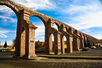 Cars parked near an aqueduct, Zacatecas State, Mexico
