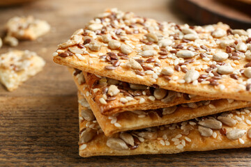 Stack of delicious crackers on table, closeup