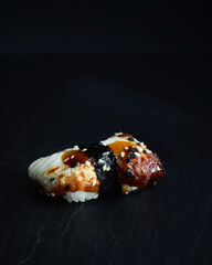 Sushi rolls. Japanese food in the restaurant. Sushi roll with eel on a dark background