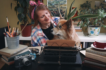 girl and dog corgi typing on a typewriter