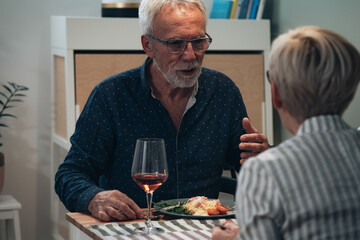 Cheerful couple have romantic dinner at home stock photo