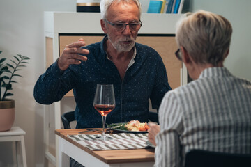 Cheerful couple have romantic dinner at home stock photo