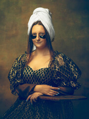 Beauty routine. Young woman as Mona Lisa, La Gioconda isolated on dark green background. Retro style, comparison of eras concept. Beautiful female model like classic historical character, old