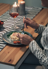 Hands of senior woman eating pasta stock photo
