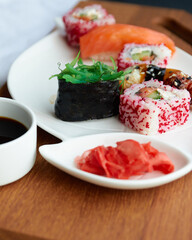 Sushi rolls. Japanese food in the restaurant. Sushi roll with salmon, vegetables, flying fish roe close-up