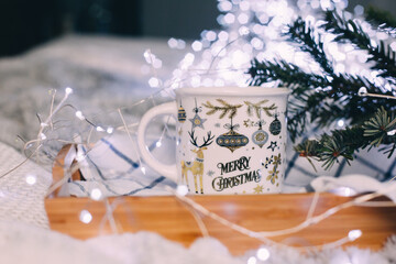 Christmas mug on a background of Christmas lights