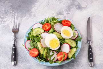 Vegetables salad on a plate served with fork and knife. Diet food concept. Healthy food