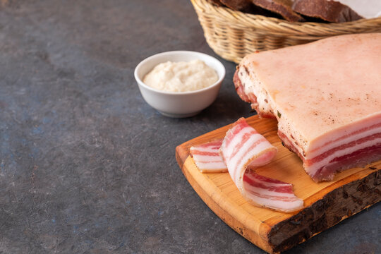 Delicious pork fatback on a wooden cutting board. Space for text