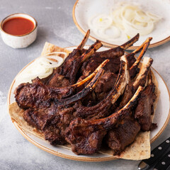 Bbq lamb on bone with onion. Closeup