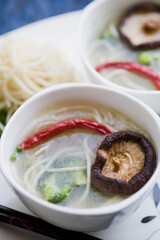 High angle view of Oriental mushroom soup with noodles