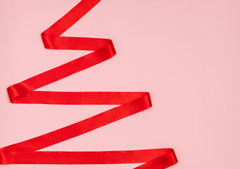 Red ribbon in the shape of a Christmas tree.