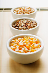 Fototapeta na wymiar Close-up of bowls of corn and lentils with soybean