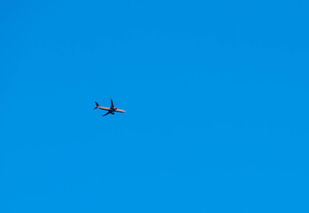 A Scandinavian airlines Boeing 737-800 flying high above the ground on route with clear blue skies.