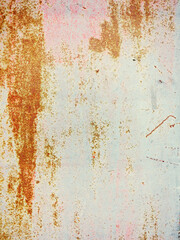 Bright multi-colored paint on rusty metal surface. Rusty metal wall, old sheet of iron covered with rust with multi-colored paint. As textured authentic background for your project