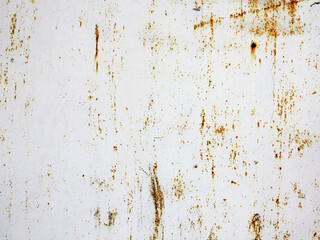Bright multi-colored paint on rusty metal surface. Rusty metal wall, old sheet of iron covered with rust with multi-colored paint. As textured authentic background for your project