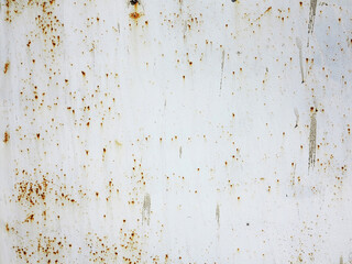 Bright multi-colored paint on rusty metal surface. Rusty metal wall, old sheet of iron covered with rust with multi-colored paint. As textured authentic background for your project