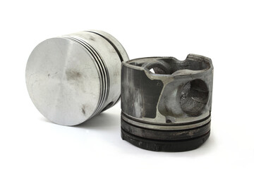 Old worn used engine pistons on white background	
