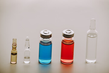 Medical vials and ampoules for injection. medicines and disease treatment. Blue and red vials and...