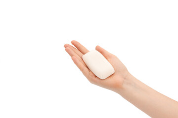 A bar of soap in female hands on a white background.