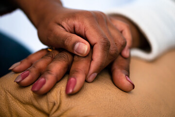close up detail of black hands of grandmother and granddaughter over each other. commitment, aging, care, support, unity concept. . - Powered by Adobe
