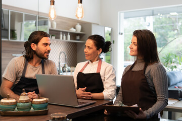 Professional latin business team with laptop discussing sales strategy and planning inside business store. business, workplace, successful, entrepreneur, occupation concept..