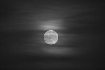 Obraz premium Black and White of Clouds passing over moon.