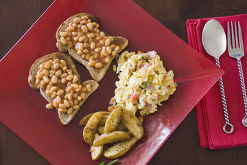 High angle view of baked beans on toasts with scrambled eggs