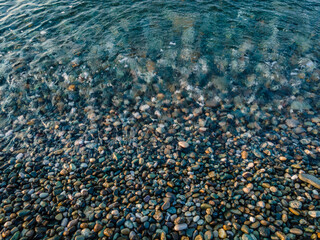 clean sea water beach covered with pebbles black sea. Adler