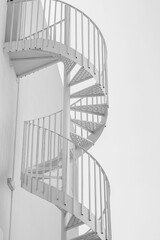 white spiral staircase against the blue sky