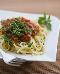 Close-up of spaghetti and meat with a fork