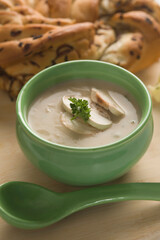 Bowl of soup served with a loaf of bread