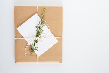 Brown Paper Package with Twine and Rosemary Sprig