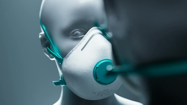 White FFP3 respirator mask with teal valve on mannequin head