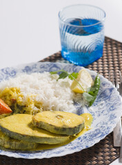 Close-up of fish curry served with rice