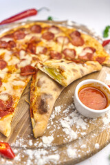 Italian pizza with pepperoni, mozzarella and tomato sauce wooden table