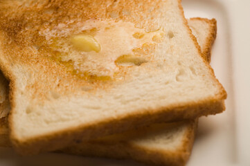 Two slices of toast with butter on a plate