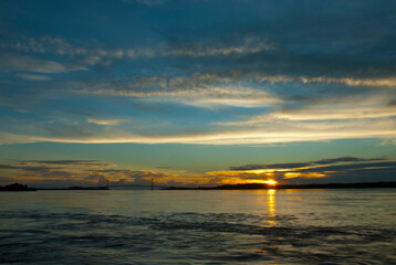 Naklejka premium Clouds over the river
