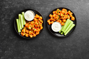 Cauliflower buffalo wings with celery and sauce