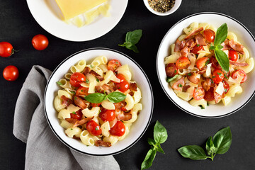 Pasta with bacon, tomato, parmesan cheese and basil leaves