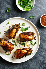Roasted quails on white plate