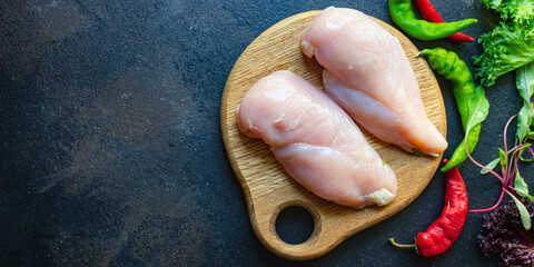 raw chicken breast meat on the table serving size top view place copy space for text keto or paleo...