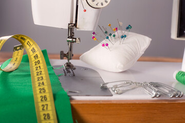 the leg of the sewing machine with a needle sews fabric