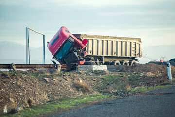 The truck lies in a ditch after the road accident