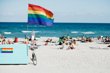 Gay pride flag fluttering on the beach, Miami Beach, Florida, USA