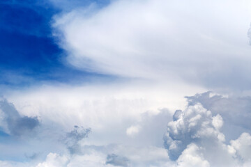 Naklejka na ściany i meble Divine sky. White fluffy clouds in the blue sky. Blue sky background with tiny clouds. Panorama
