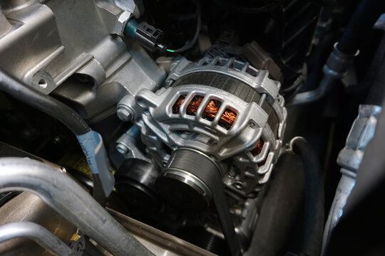Generator (alternator) installed in the engine of a modern car.